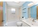 Bright bathroom with blue accents, a tub and shower combo and a large vanity at 1173 Belmar Ave, Port Charlotte, FL 33948
