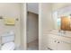 Bathroom with vanity sink, toilet, and a fully tiled walk-in shower at 1173 Belmar Ave, Port Charlotte, FL 33948