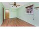 Bedroom with wood floors, a ceiling fan and a window providing natural light at 1173 Belmar Ave, Port Charlotte, FL 33948
