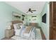 Stylish bedroom with modern ceiling fan, warm lighting and ample natural light at 1173 Belmar Ave, Port Charlotte, FL 33948
