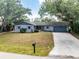 Charming single-story home with a well-maintained lawn and mature shade trees at 1173 Belmar Ave, Port Charlotte, FL 33948