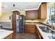 Beautiful kitchen featuring wood cabinets, stainless steel refrigerator, and countertop space at 1173 Belmar Ave, Port Charlotte, FL 33948
