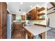 Well-lit kitchen with wood cabinets, stainless steel appliances, and a breakfast bar at 1173 Belmar Ave, Port Charlotte, FL 33948
