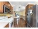 Traditional kitchen with wood cabinets and modern stainless steel appliances and eat in breakfast area at 1173 Belmar Ave, Port Charlotte, FL 33948