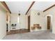 Inviting living room featuring beamed ceilings, wood look floors, and a front door with sidelight windows at 1173 Belmar Ave, Port Charlotte, FL 33948