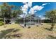 Enclosed pool area featuring clear blue water, a screened enclosure, and well-maintained surroundings at 1173 Belmar Ave, Port Charlotte, FL 33948