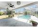 Screened-in pool area with a refreshing pool, ceiling fan and ample deck space for entertaining at 1173 Belmar Ave, Port Charlotte, FL 33948