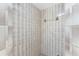 Neutral tiled shower with glass doors and a built in towel rack at 1173 Belmar Ave, Port Charlotte, FL 33948