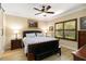Cozy bedroom with dark wood accents, a ceiling fan, and a decorative painting at 1230 Collier Pl, Venice, FL 34293
