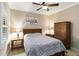 Serene bedroom with a queen bed, bedside tables, wooden dresser, and neutral decor at 1230 Collier Pl, Venice, FL 34293