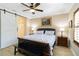 Charming bedroom featuring dark wood accents, a ceiling fan, and a decorative painting at 1230 Collier Pl, Venice, FL 34293