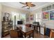 Cozy home office featuring a vintage desk, built-in shelves and a ceiling fan at 1230 Collier Pl, Venice, FL 34293