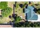 Aerial perspective shows the property's roof and its yard shaded by mature trees within the neighborhood at 1381 Fargo St, Port Charlotte, FL 33952
