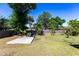 Spacious backyard featuring a wooden deck, mature trees, and a well-maintained lawn, perfect for outdoor activities at 1381 Fargo St, Port Charlotte, FL 33952