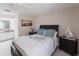 Comfortable bedroom featuring tile floor, ceiling fan, dark wood furnishings, and soft blue accents at 1381 Fargo St, Port Charlotte, FL 33952