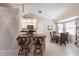 Open kitchen with granite countertops, white cabinetry, a breakfast bar, and an adjacent dining area at 1381 Fargo St, Port Charlotte, FL 33952