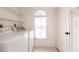 Bright laundry room with modern appliances including a washer and dryer, plus storage space at 1381 Fargo St, Port Charlotte, FL 33952