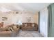 Bright living room featuring neutral walls, a ceiling fan, comfortable sofas, and decor at 1381 Fargo St, Port Charlotte, FL 33952