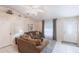 Cozy living room showing neutral walls, tiled floors, comfortable sofas, and transom window at 1381 Fargo St, Port Charlotte, FL 33952