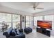 Cozy sunroom with large windows offering bright, natural light, tile flooring, and a comfortable chair with ottoman at 1381 Fargo St, Port Charlotte, FL 33952