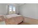 Bright bedroom featuring plush carpet and abundant natural light from large windows overlooking a field at 15975 Mulrion Blvd, Punta Gorda, FL 33982