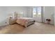 Well-lit bedroom featuring neutral colors and a comfortable bed with bedside table at 15975 Mulrion Blvd, Punta Gorda, FL 33982