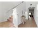 Bright hallway with staircase, tasteful decor, and wood-look flooring at 15975 Mulrion Blvd, Punta Gorda, FL 33982