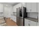 Modern kitchen featuring white cabinetry, stainless steel appliances, and granite countertops at 15975 Mulrion Blvd, Punta Gorda, FL 33982