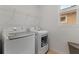 A bright laundry room featuring modern appliances and ample shelving at 15975 Mulrion Blvd, Punta Gorda, FL 33982