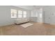 Bright living area featuring a white sofa, neutral carpet, and multiple windows for natural light at 15975 Mulrion Blvd, Punta Gorda, FL 33982