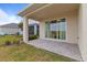 Covered patio with tiled flooring and glass sliding door, perfect for enjoying outdoor relaxation at 15975 Mulrion Blvd, Punta Gorda, FL 33982