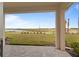 Covered patio with paved flooring, overlooking a lush green yard and serene lake view at 15975 Mulrion Blvd, Punta Gorda, FL 33982