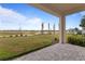 Enjoy outdoor living on this patio overlooking lush lawn and newly planted palm trees at 15975 Mulrion Blvd, Punta Gorda, FL 33982