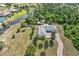 Aerial view of a home with a lush backyard, a creek, and mature trees in a waterfront community at 17506 Cape Horn Blvd, Punta Gorda, FL 33955