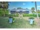 Backyard view showcasing a screened-in patio area with an outdoor seating and lush landscaping at 17506 Cape Horn Blvd, Punta Gorda, FL 33955