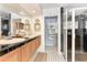Bathroom boasts a double vanity with oak cabinets, black tile countertops, and a walk-in glass shower at 17506 Cape Horn Blvd, Punta Gorda, FL 33955