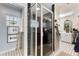 Elegant bathroom with glass shower, stylish black and white tile, and a view into the walk-in closet at 17506 Cape Horn Blvd, Punta Gorda, FL 33955