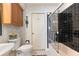 Charming bathroom with a tiled shower, floral wallpaper, and a classic sink and toilet at 17506 Cape Horn Blvd, Punta Gorda, FL 33955