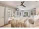Sun-filled bedroom with French doors, wood floors, a cozy sitting area, and neutral decor at 17506 Cape Horn Blvd, Punta Gorda, FL 33955