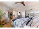 Serene bedroom featuring a ceiling fan, hardwood floors, dresser, and accent furniture at 17506 Cape Horn Blvd, Punta Gorda, FL 33955