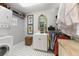 Functional walk-in closet with washer and dryer, shelving, and a small cabinet with clothing rods at 17506 Cape Horn Blvd, Punta Gorda, FL 33955