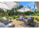 Outdoor deck featuring wicker furniture, white cushions, and a set of patio umbrellas at 17506 Cape Horn Blvd, Punta Gorda, FL 33955