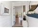 Inviting entryway with wood-look flooring, white shiplap walls, and decorative coastal accents at 17506 Cape Horn Blvd, Punta Gorda, FL 33955
