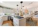 Modern kitchen featuring a kitchen island, range, ample cabinetry, and an open layout at 17506 Cape Horn Blvd, Punta Gorda, FL 33955