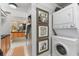 Convenient laundry area with stacked washer/dryer and decorative wall art adds character to the home at 17506 Cape Horn Blvd, Punta Gorda, FL 33955