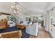 Bright, open-concept living room with nautical accents, hardwood floors, and a modern chandelier at 17506 Cape Horn Blvd, Punta Gorda, FL 33955