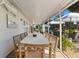 Inviting screened-in patio with a long dining table and comfortable seating for outdoor gatherings at 17506 Cape Horn Blvd, Punta Gorda, FL 33955
