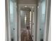 Hallway view into a modern, renovated bathroom with a new glass shower at 21215 Cottonwood Ave, Port Charlotte, FL 33952