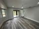 Bedroom features modern floors, a ceiling fan, plenty of natural light and access to screened in patio at 21215 Cottonwood Ave, Port Charlotte, FL 33952