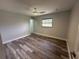 Open bedroom featuring modern floors, neutral paint, ceiling fan and natural light at 21215 Cottonwood Ave, Port Charlotte, FL 33952